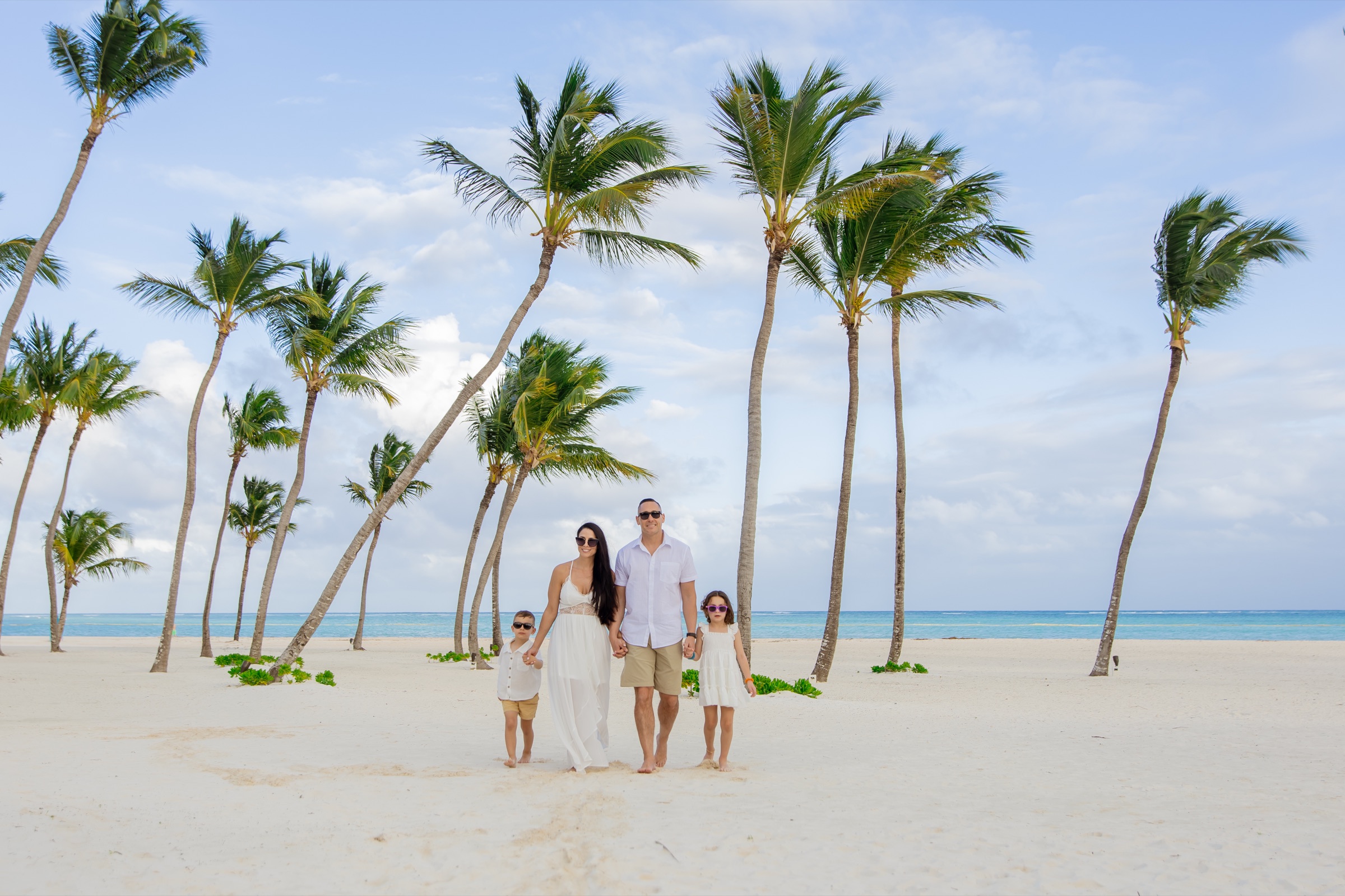 Family walking the Cap Cana beach
